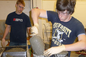students making concrete cylinders