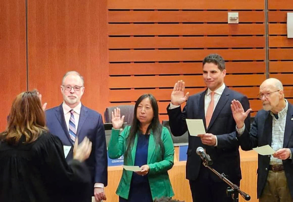 a group of people swearing-in during a council ceremony